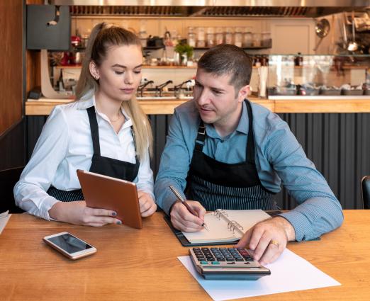 two coffee shop workers at a table