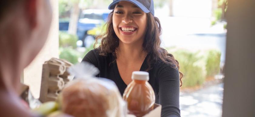 woman delivering meals to a home